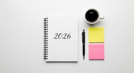 Minimalist flat lay of a 2026 planner, coffee, pen, and sticky notes on a white desk