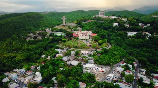 Aerial view of downtown Ponce in Puerto Rico with the Cross on the Hill and the manor house museum Castillo Serralles. Historic buildings of the island in the Caribbean.