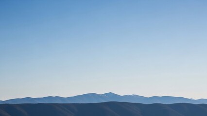 Serene Mountain Range Landscape with Clear Blue Sky and Distant Hills