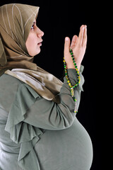portrait of pregnant muslim woman,prayer