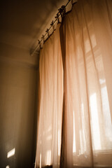Background of transparent curtains with sun light in room close up. Good morning. Selective focus.
