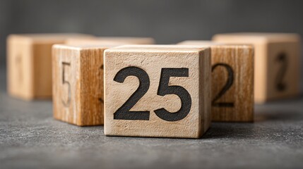 Clean wooden block calendar displaying December 25, matte grey surface