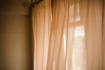 Background of transparent curtains with sun light in room close up. Good morning. Selective focus.