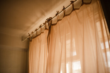 Background of transparent curtains with sun light in room close up. Good morning. Selective focus.