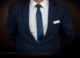Hotel receptionist standing infront of computer