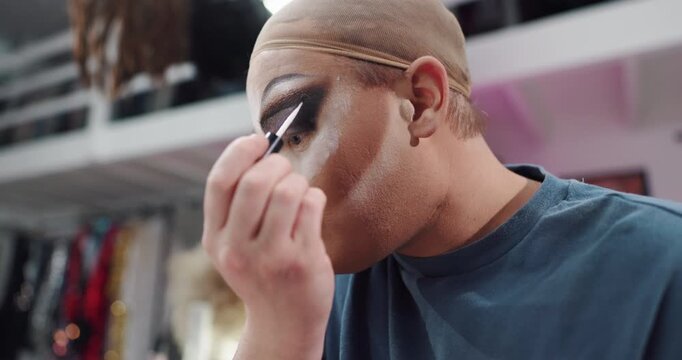 Eyeshadow, makeup and backstage with drag performer in studio for beauty, lgbt culture and cosmetics. Pride, product application and identity with person in dressing room for makeover and artist