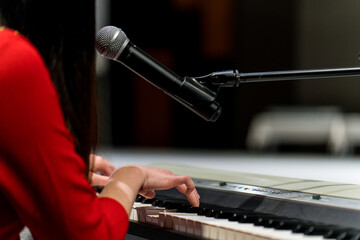 beautiful young woman playing the piano