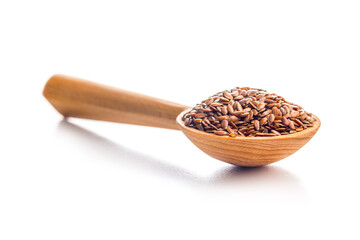 Linseed or flaxseed. Healthy flax seed on wooden spoon isolated on white background.