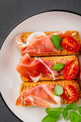 jamon bruschetta prosciutto appetizer portioned tapas dish natural tasty snack fresh delicious gourmet food background on the table rustic top view copy space