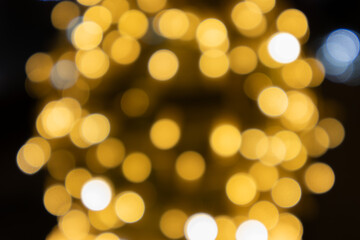 Obraz premium An abstract colorful background of warm-toned lights. In anticipation of Christmas and the holidays.