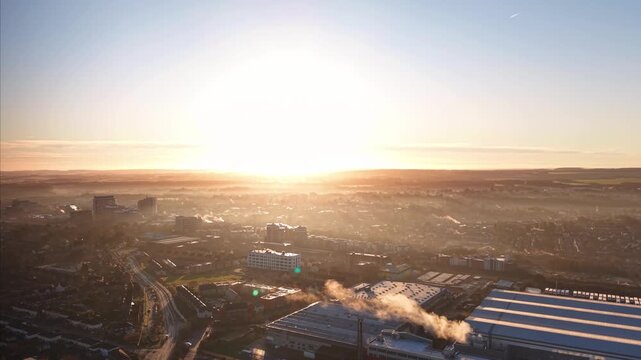 Atmospheric Sunrise Cityscape With Fog and Chimney Steam. Basingstoke. UK