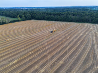 Harvested field with straw bales, tractor and trailer near Weiterstadt, Hesse