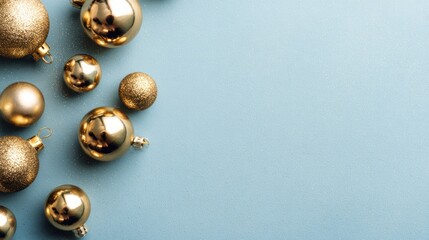 Gold Christmas decoration on blue pastel background, top view, flat lay