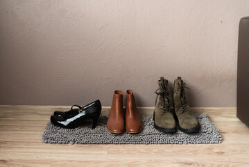 Shoes neatly arranged on rug near wall in home interior