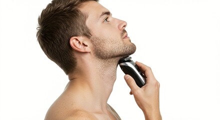 A man with a trimmed beard shaves his face and neck using an electric razor on a white background.