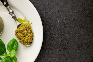 Pesto sauce basil, olive oil, parmesan, pine nuts, garlic natural product tasty snack fresh delicious gourmet food background on the table rustic top view copy space