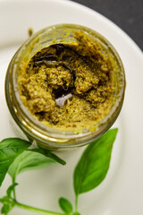 Pesto sauce basil, olive oil, parmesan, pine nuts, garlic natural product tasty snack fresh delicious gourmet food background on the table rustic top view copy space