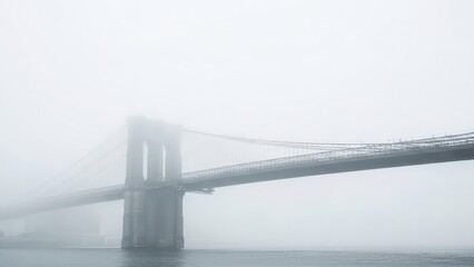 Iconic brooklyn bridge shrouded in thick, atmospheric fog over the water in new york city, moody urban landscape