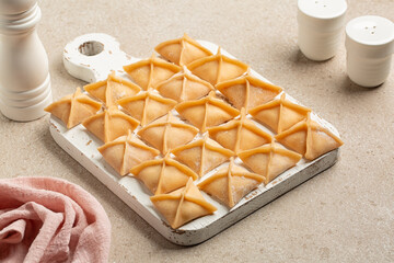Wooden cooking board with raw fagottini,  is a filled pasta with ricotta and vegetable. Homemade Italian food.