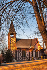 Golden light shines on the historic church tower and structure. The Stary Smokovec, settlement and the administrative center of the High Tatras National Park in Slovakia, Europe.