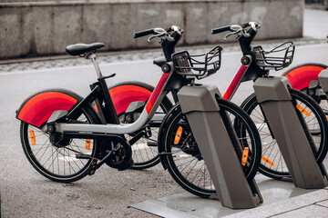 Colorful bicycles parked in a bike-sharing station, showcasing vibrant wheel designs and modern urban infrastructure, promoting eco-friendly transportation options for city dwellers