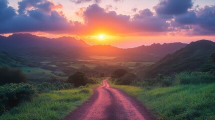Road between lush green mountains under orange and pink sky 