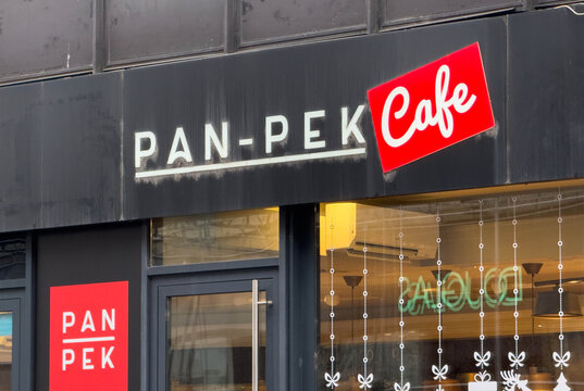 Zagreb, Croatia - December 14, 2025: Pan-Pek Cafe storefront with modern signage and inviting atmosphere, showcasing vibrant colors and urban design elements in a bustling city setting