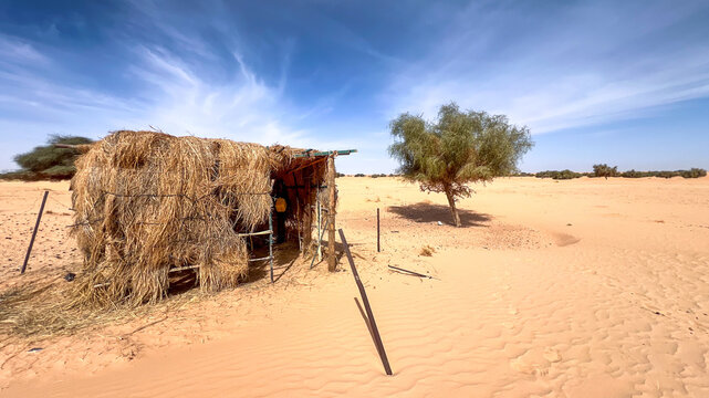 Mauritanian desert. A makeshift shelter made of straw in the middle of the desert