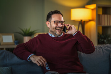 Man making secure online payment with smart phone and credit card at home