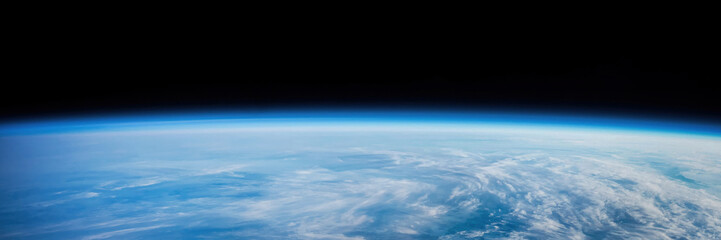 Blue planet Earth horizon view from space. Orbit of Earth planet. Wide horizontal background of planet with sky and clouds. Elements of this image furnished by NASA. Not AI content