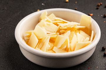 Parmesan cheese slices natural healthy food ingredient appetizer fresh tasty table setting gourmet food background on the table rustic food top view copy space