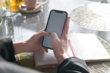 Close-up of a hand holding a phone and typing a message, close-up.