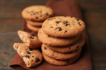 Yummy chocolate chip cookies on wooden table, closeup