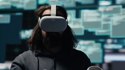 Male spy bypasses network security and engages in cyber intrusion with vr glasses, programming code for data breach and identity theft. Covert cyber operations through infiltration. Camera A.