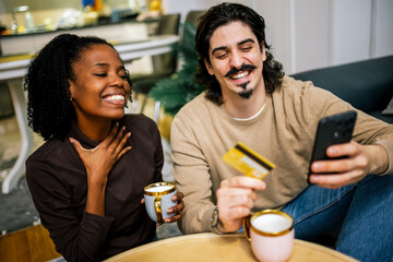 Happy Couple Shopping Online with Card and Phone