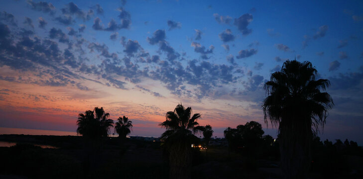 Spectacular sunset at Coral Bay offers a direct view of the sun setting over the Mediterranean Sea.