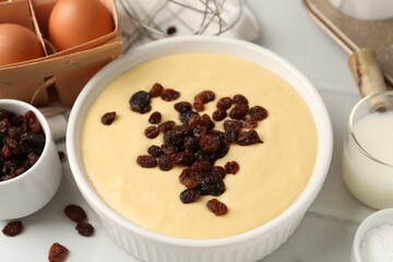 Ingredients for making muffins on white table, closeup