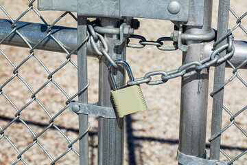 Chain and padlock on gate. Property security, crime prevention and lock maintenance concept.
