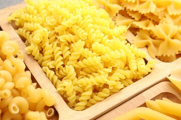 Different types of raw pasta as background, closeup