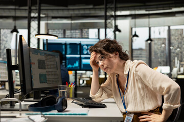 Female employee sad and worried about cryptocurrency market fall, monitoring live stock market trends going downward and losing money. Dealing with decreasing forex numbers and inflation.