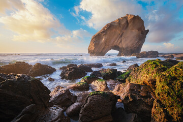 Stunning sunset at Penedo do Guincho with ocean waves at Praia da Santa Cruz
