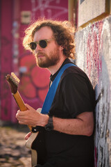 Street musician playing electric guitar in the street