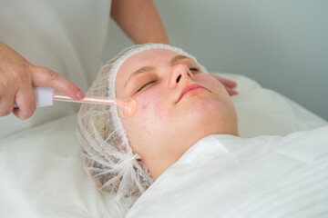 Electrotherapy session for skin rejuvenation in a beauty salon