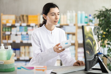 Female pharmacist searches for information about medicines on the Internet