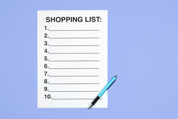 Top view of a shopping list and pen on a purple background. Flat lay concept for describing the shopping process, retail planning, organization, and consumerism. Clean workspace with space for text.