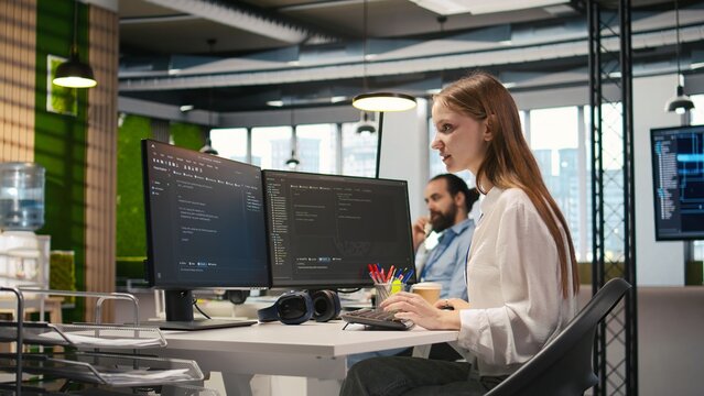 Happy female programmer dancing on office desk chair, pleased after managing to streamline workflows with AI. Cheerful worker celebrating successfully implementing neural networks, camera A