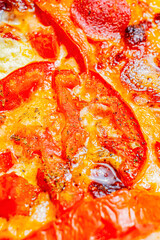 Close-up of a slice of pizza with homemade tomato sauce, cheese, fresh basil, and olive oil.