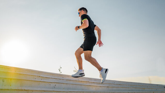 Person running up steps in bright sunlight