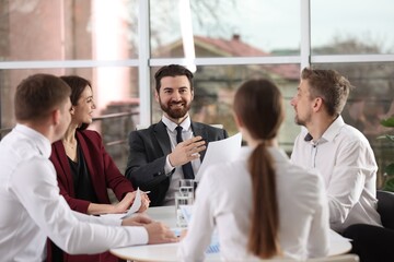 Businesspeople working together at table in office