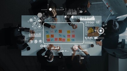 Diverse professionals engage in a collaborative meeting around a table filled with sticky notes,...